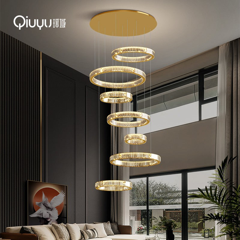 Large chandelier in the middle of the building is modern and minimalist with jumping floors, light luxury, empty living room, crystal lamp, villa duplex floor chandelier